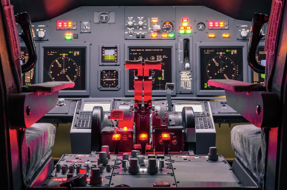 A pilot's cockpit with hundreds of knobs and switches